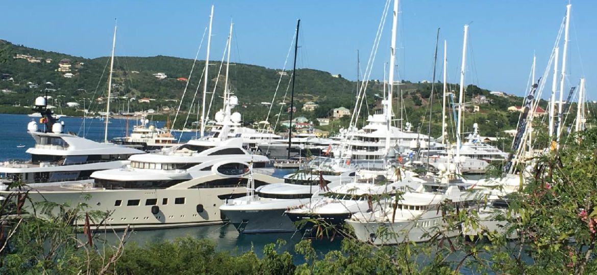 A cluster of superyachts anchored in a peaceful location