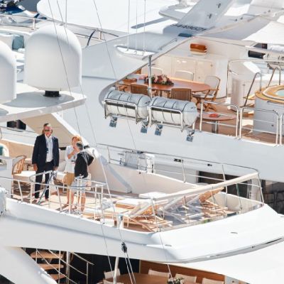 A small crowd engaged in conversation on a superyacht discussing a collaboration